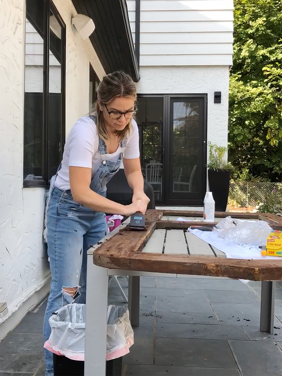 woman scraping door on table