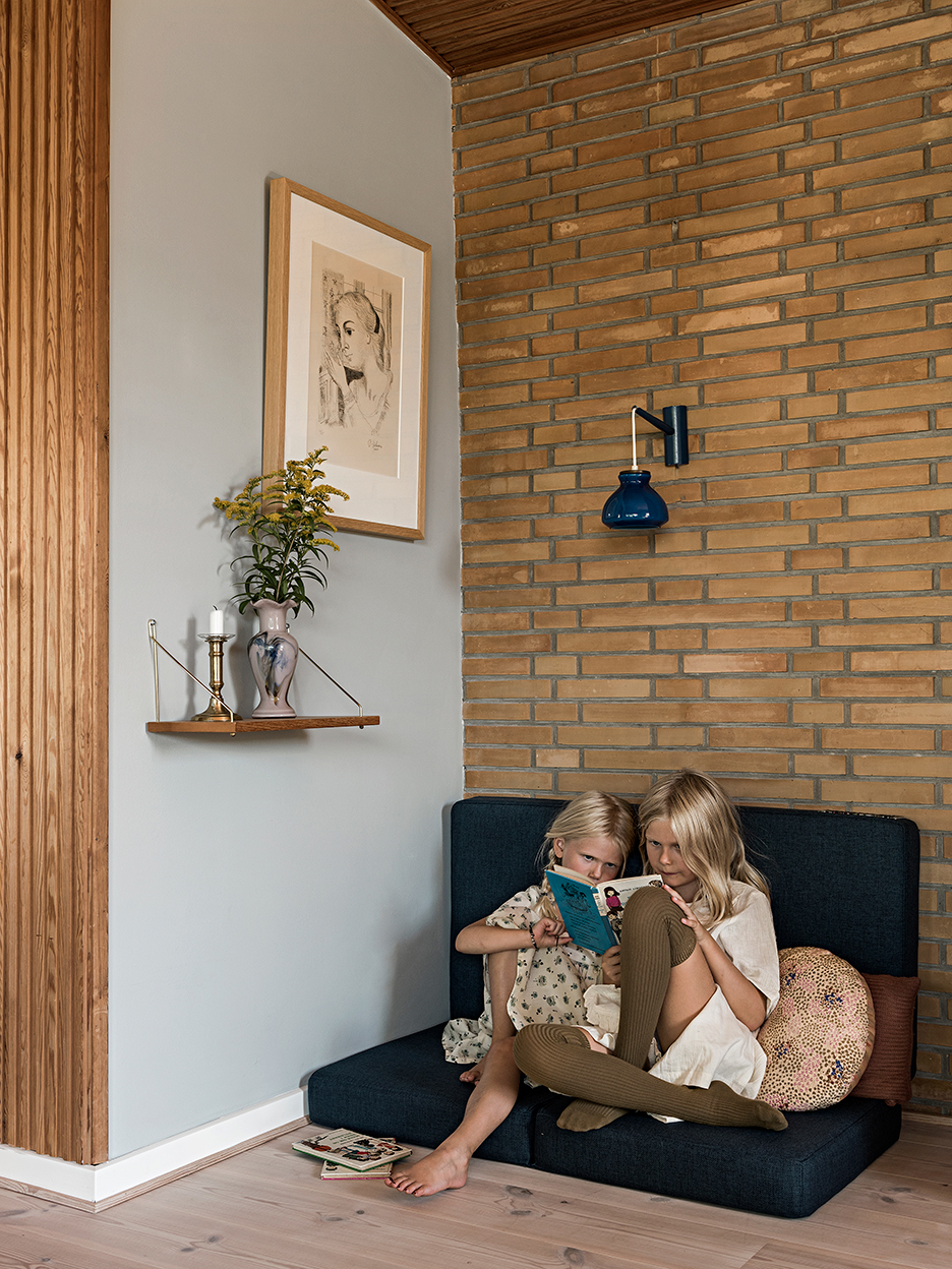 boy and girl reading on little sofa