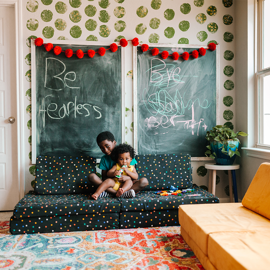 boy holding baby on floor sofa