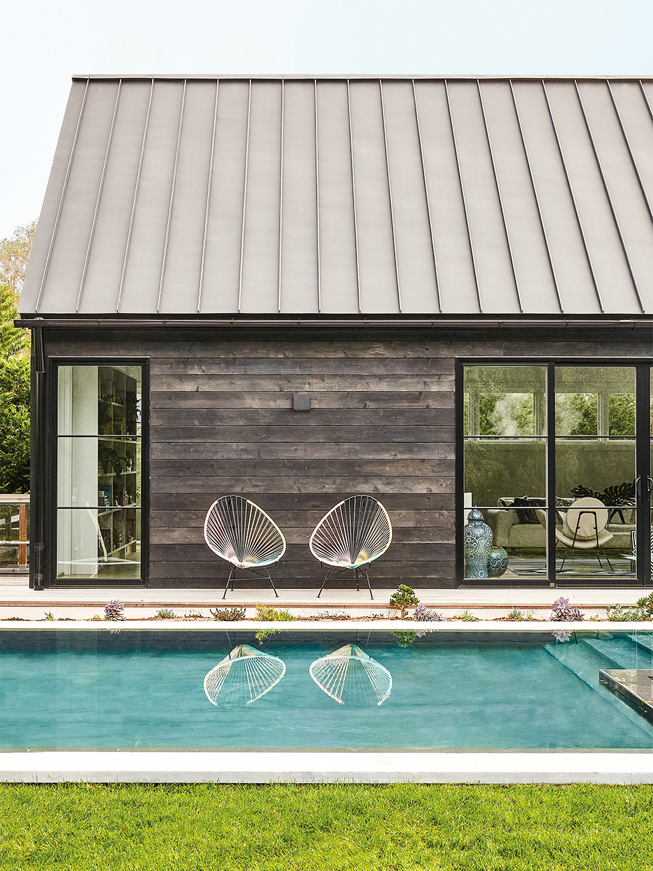 Contemporary black shou sugi ban home with pool
