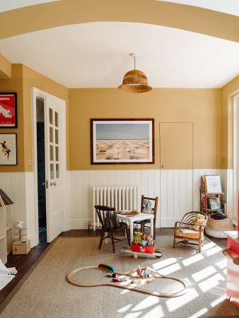 Playroom with yellow walls and woven pendant light