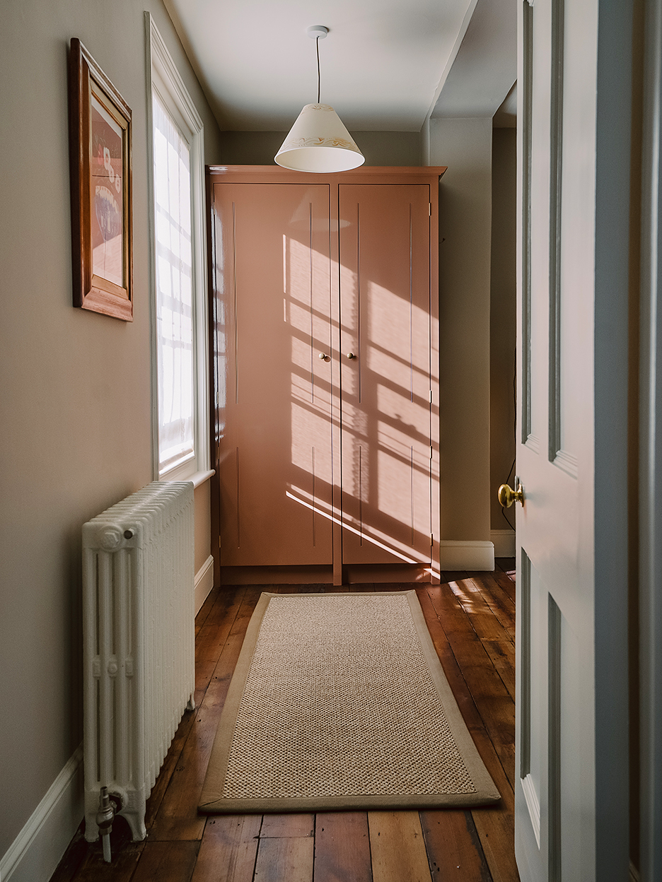 Pink built-in wardrobe in walk-in closet