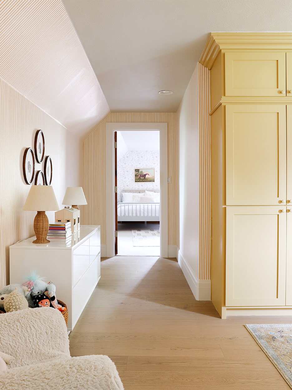 Yellow playroom with striped wallpaper