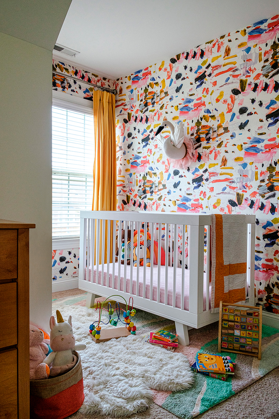 nursery with multicolor paint stroke wallpaper