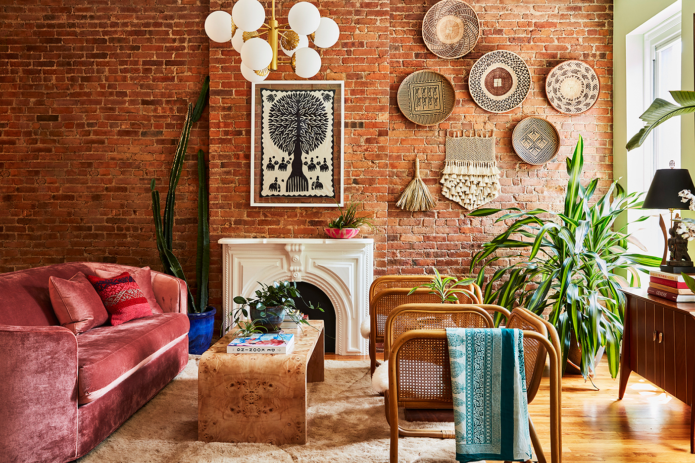 living room with pink velvet sofa and hanging baskets