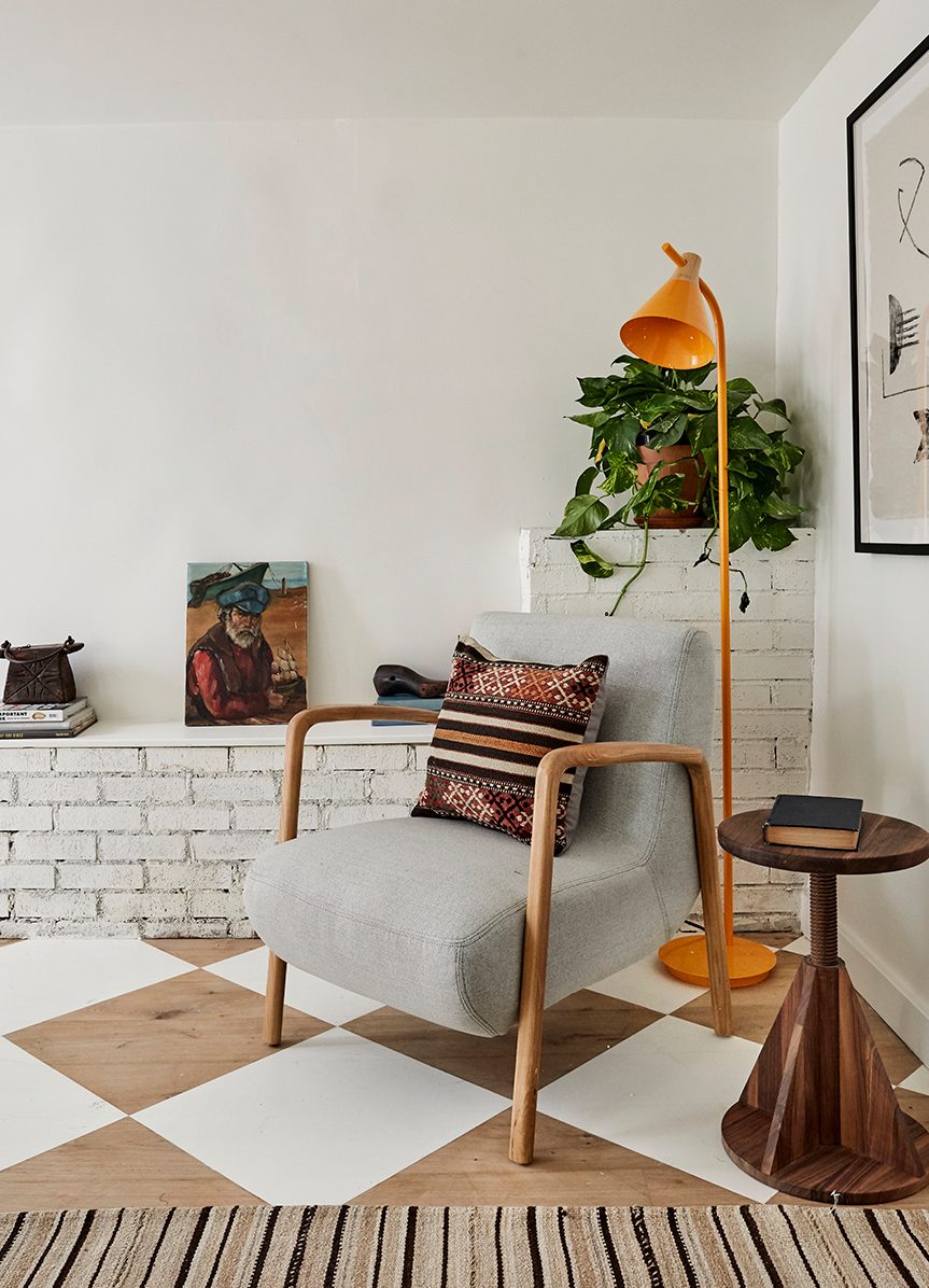 mid entury chair nextg to orange floor lamp