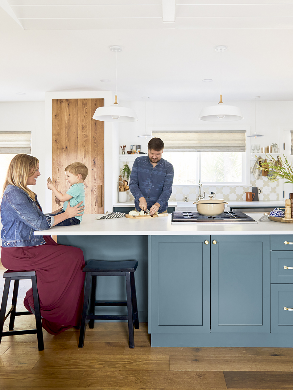 Family in blue-green kitchen