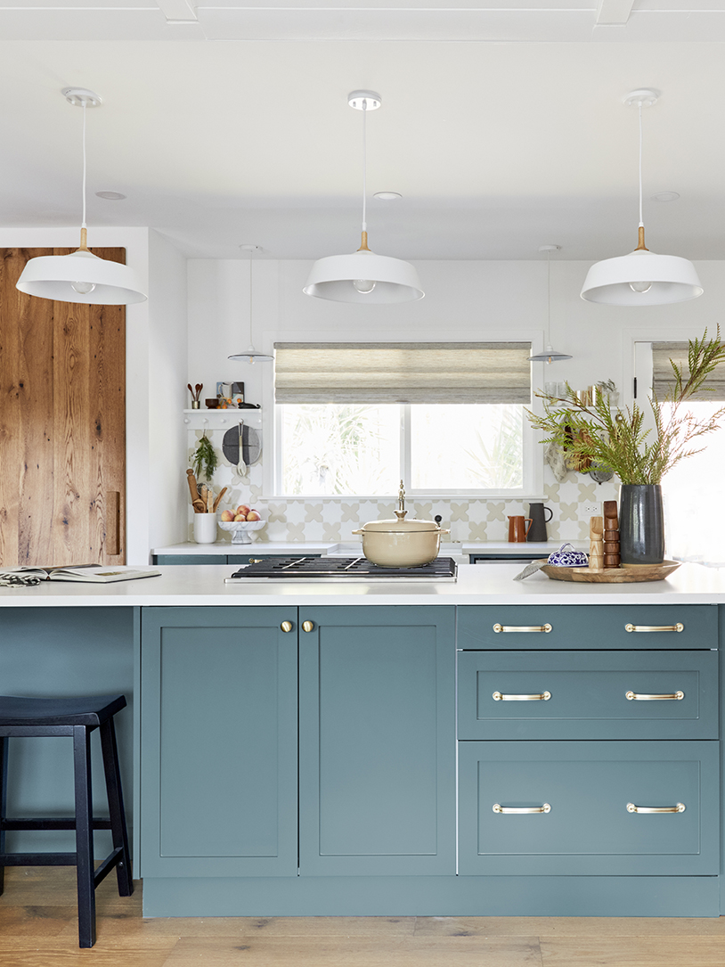 Blue-green kitchen with oak pantry door