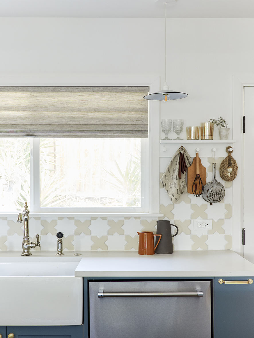 Sink underneath window with patterned backsplash