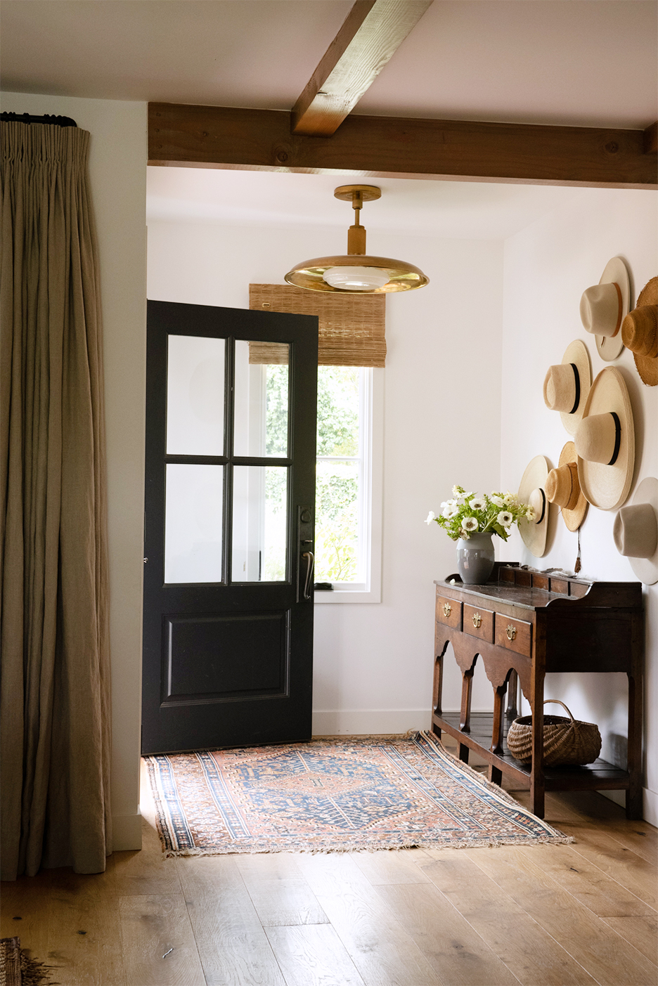 entryway with hats on the wall