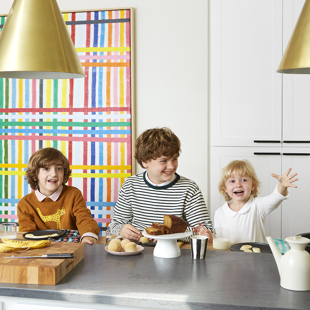 three kids at a kitchen counter