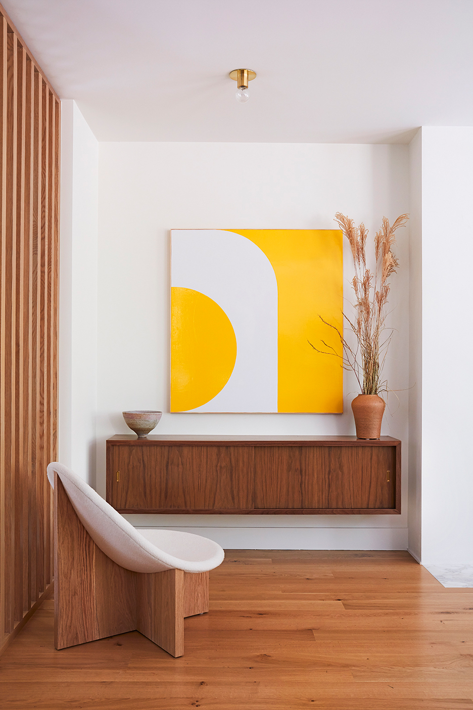 floating credenza with yellow art