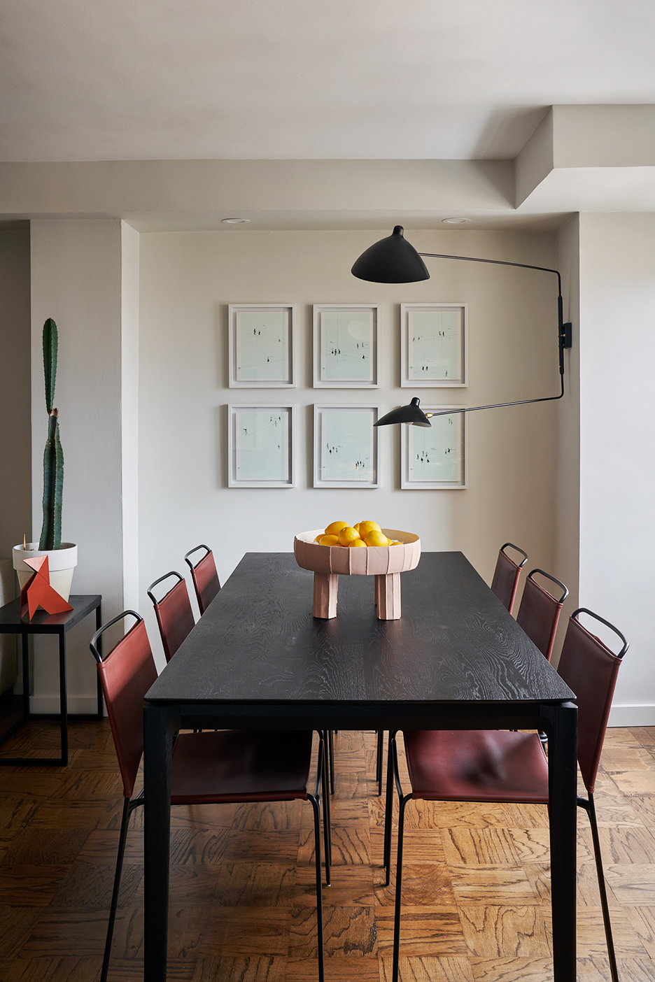 Dining room with wall sconce and leather chairs