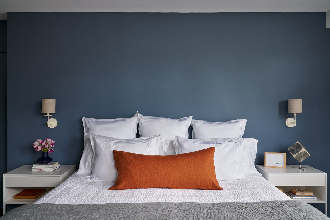 Blue bedroom with white linens