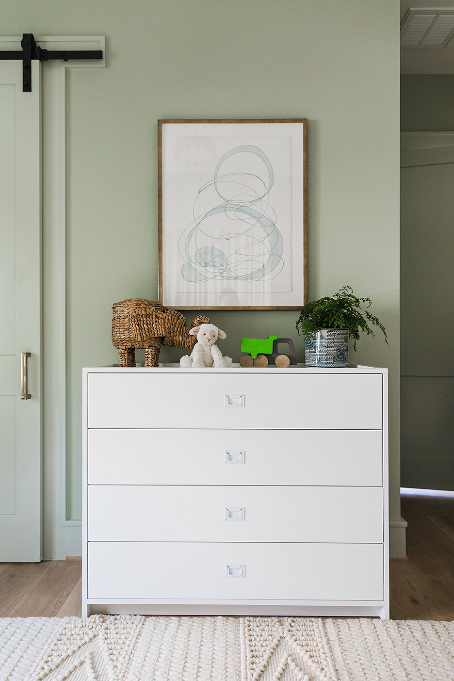 a nursery with a dresser