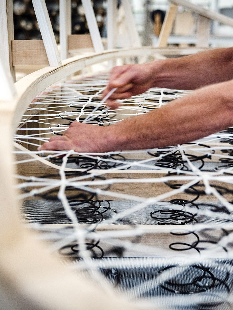 a man stretching upholstery