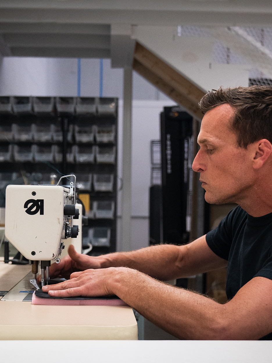 a man sewing fabric