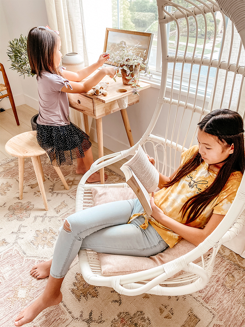 girl at desk and girl in swing