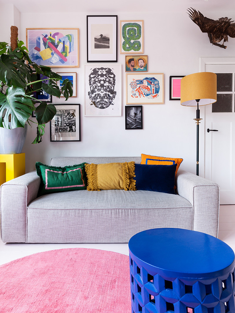 living room with art and pink rug