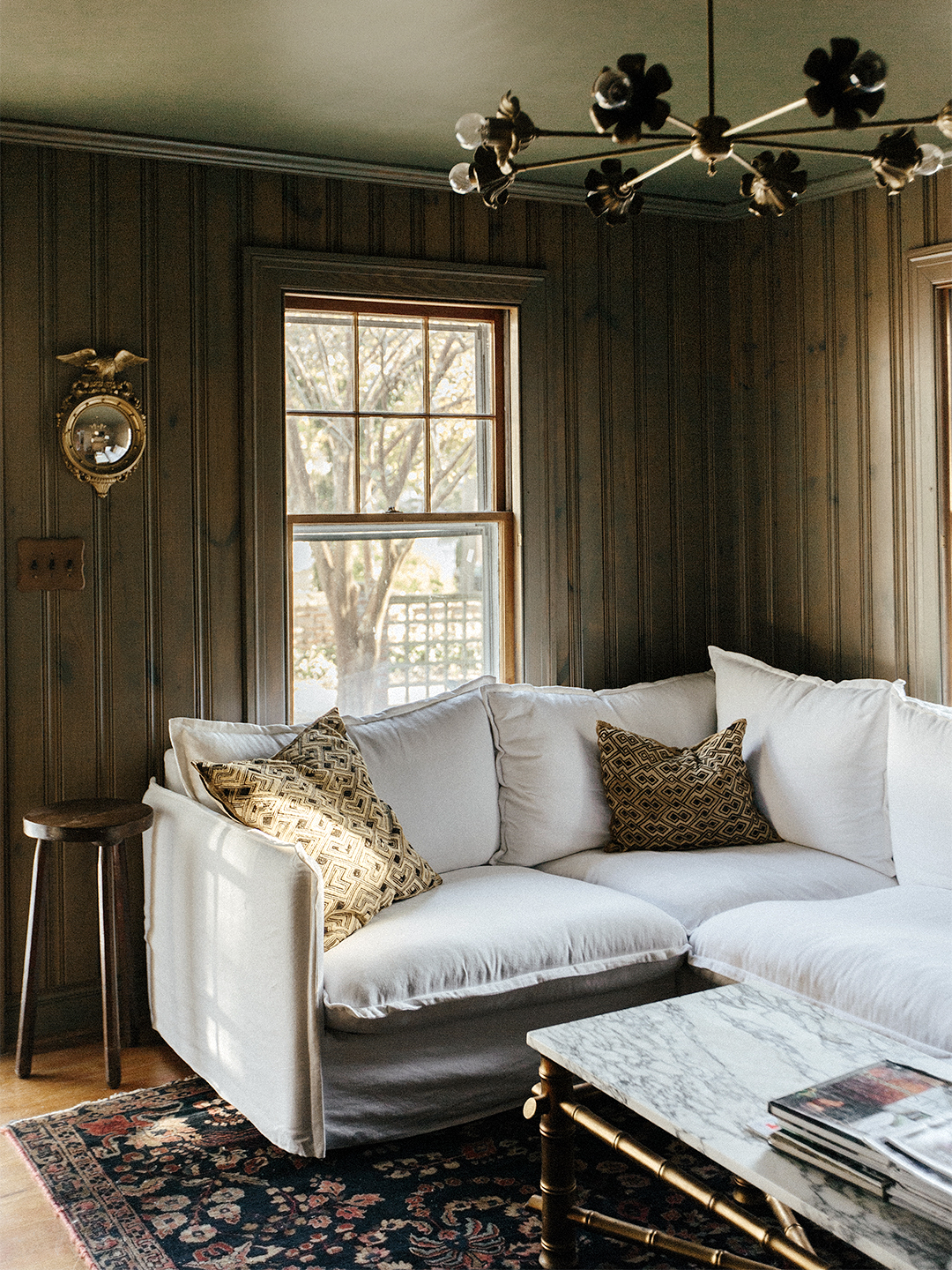 cozy green den with white couch