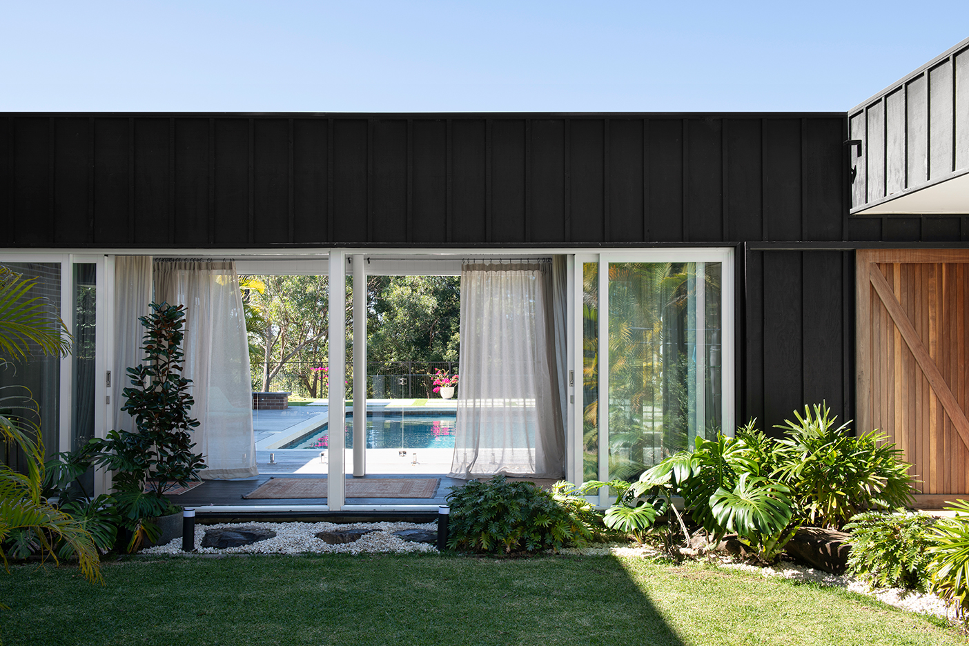 black house with grassy yard