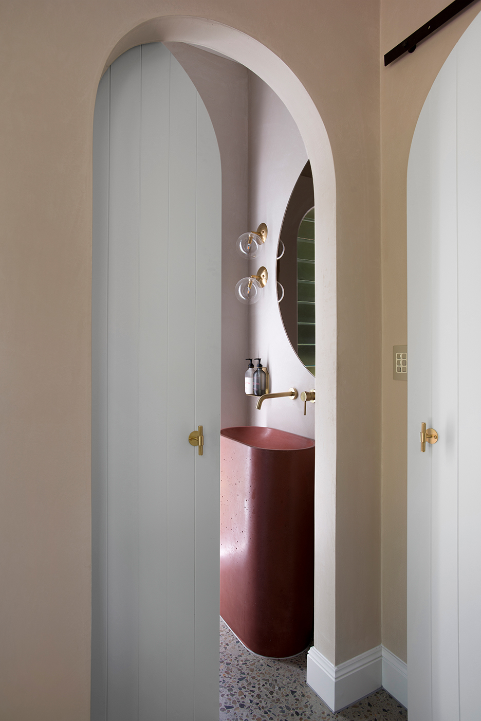 powder room with curved red sink