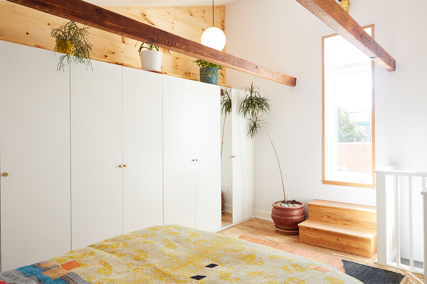 airy bedroom with wood beams