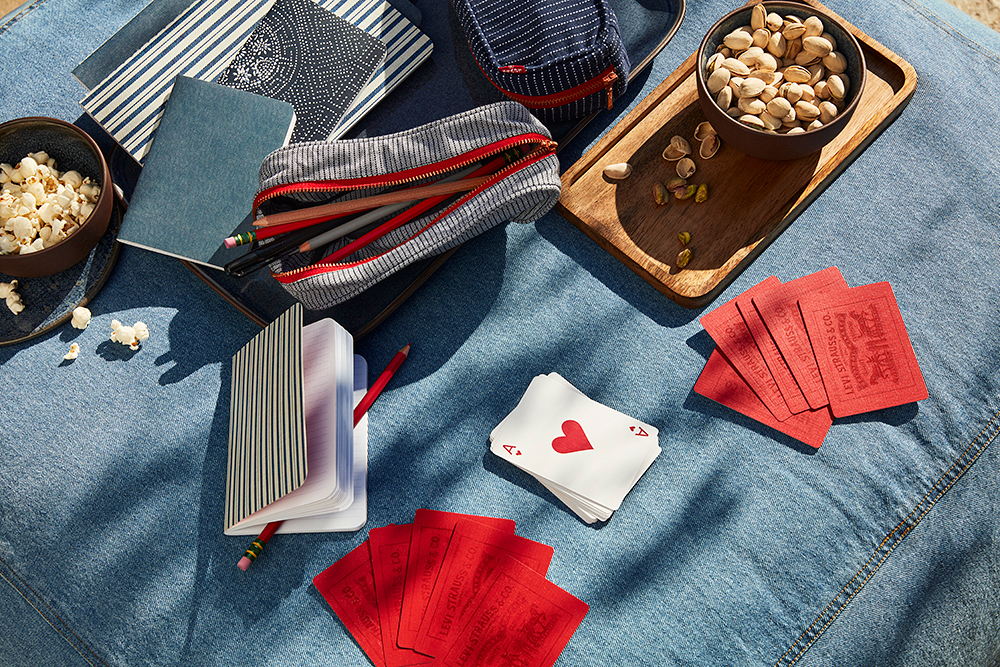 Denim picnic blanket with accessories and games on top