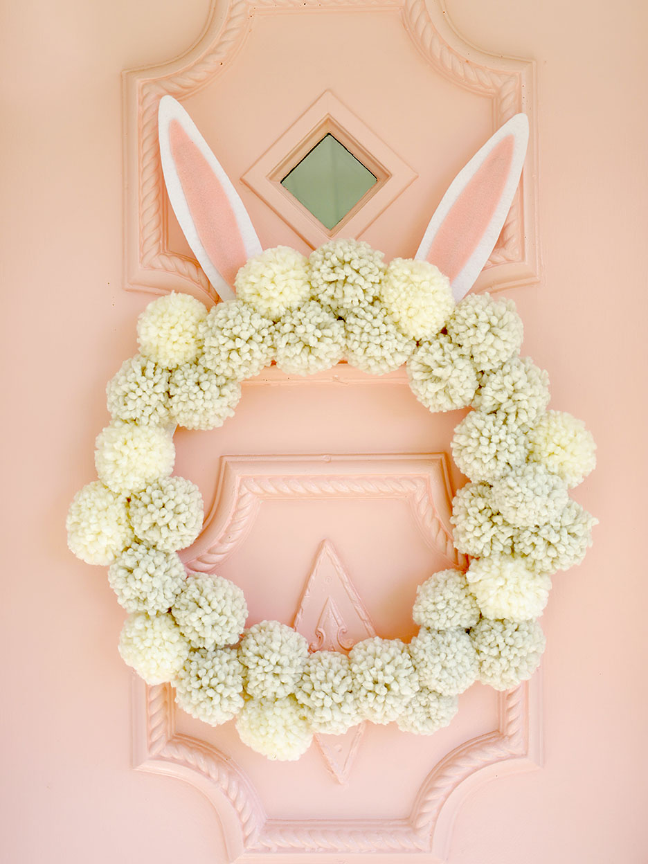 pom pom wreath on pink door