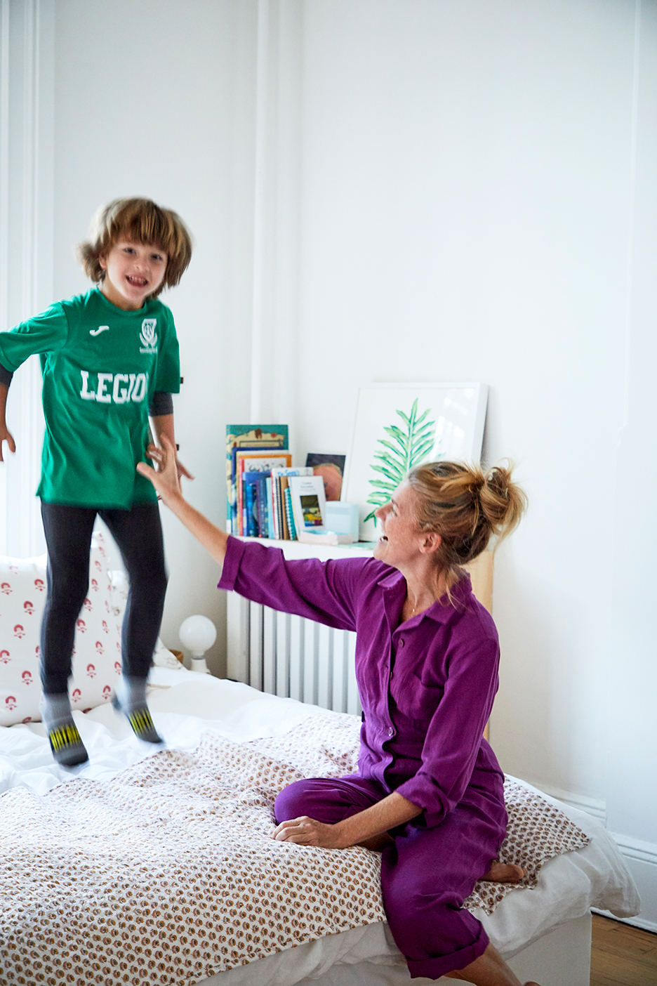 boy jumping on bed