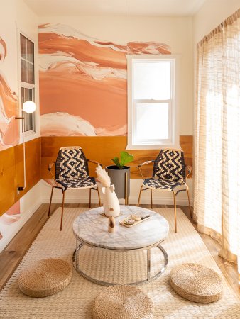 pink and white painterly wallpaper in a tiny sitting room