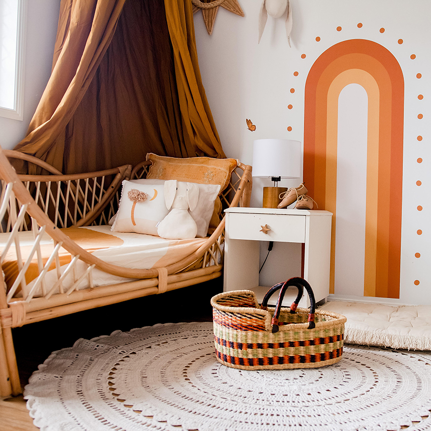 Terracotta rooms - bed with a fabric hanging and painted mural