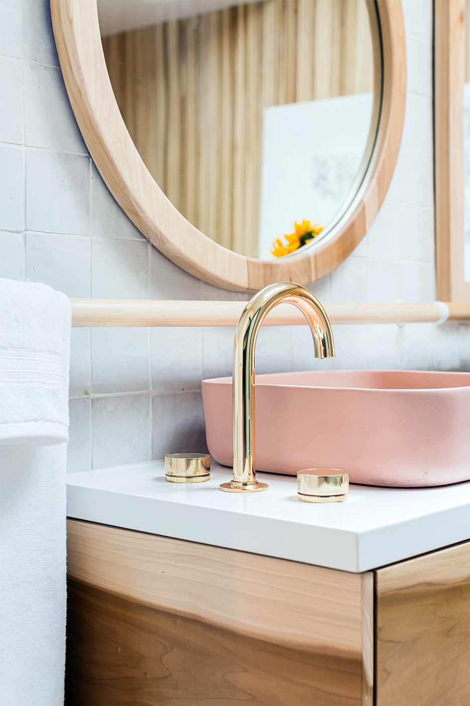 brass faucet on countertop next to sink