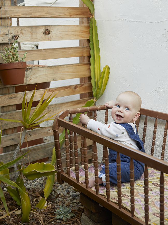 Baby in crib in backyard garden