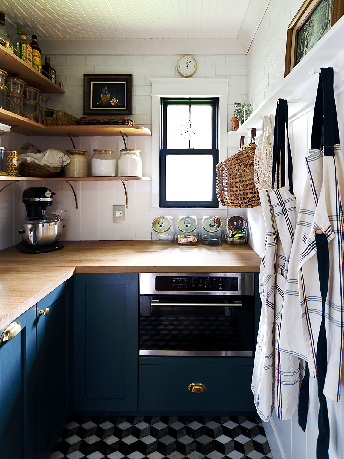 small kitchen with window and blue cabinets