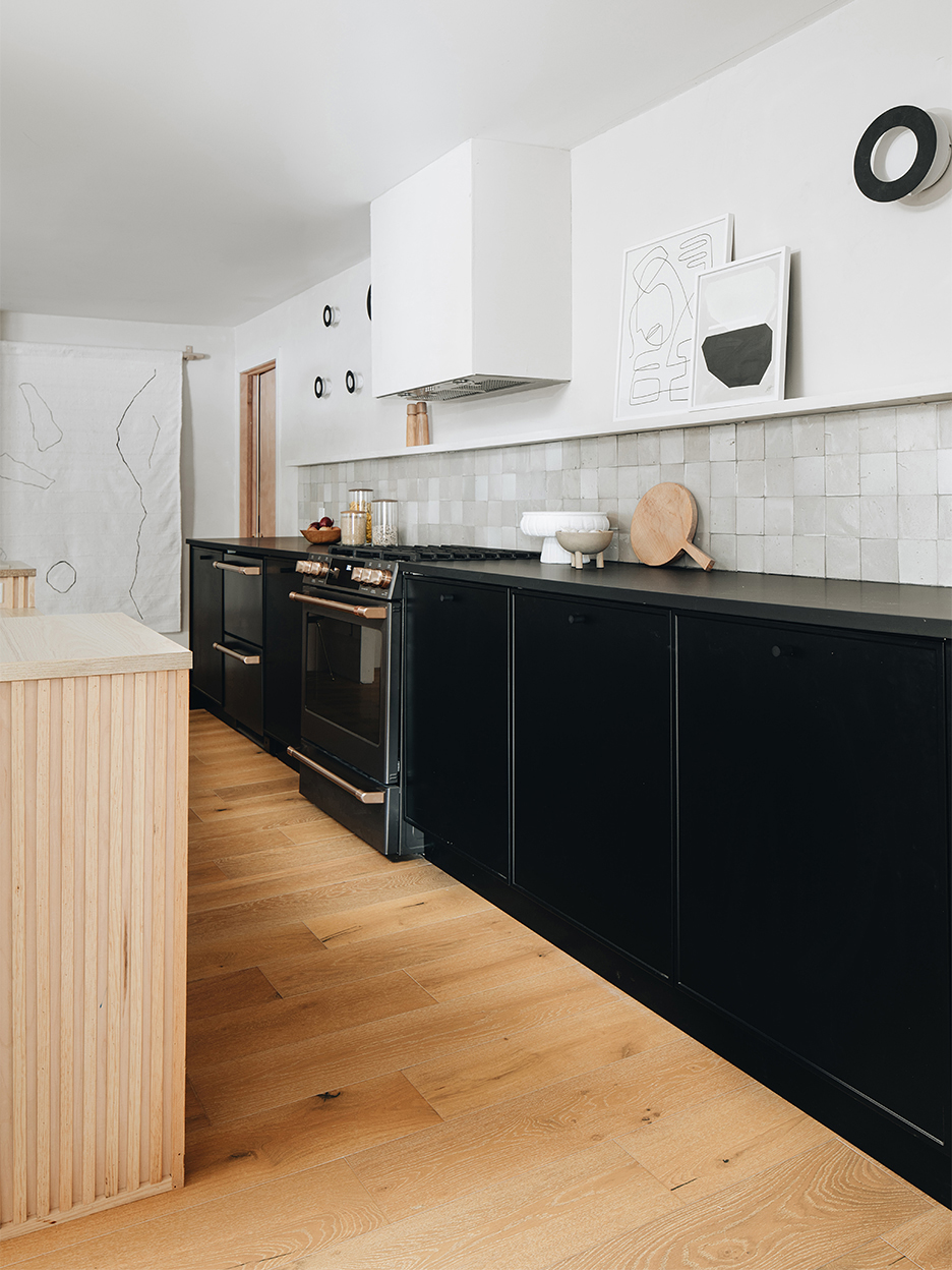 black cabinets and wood floors