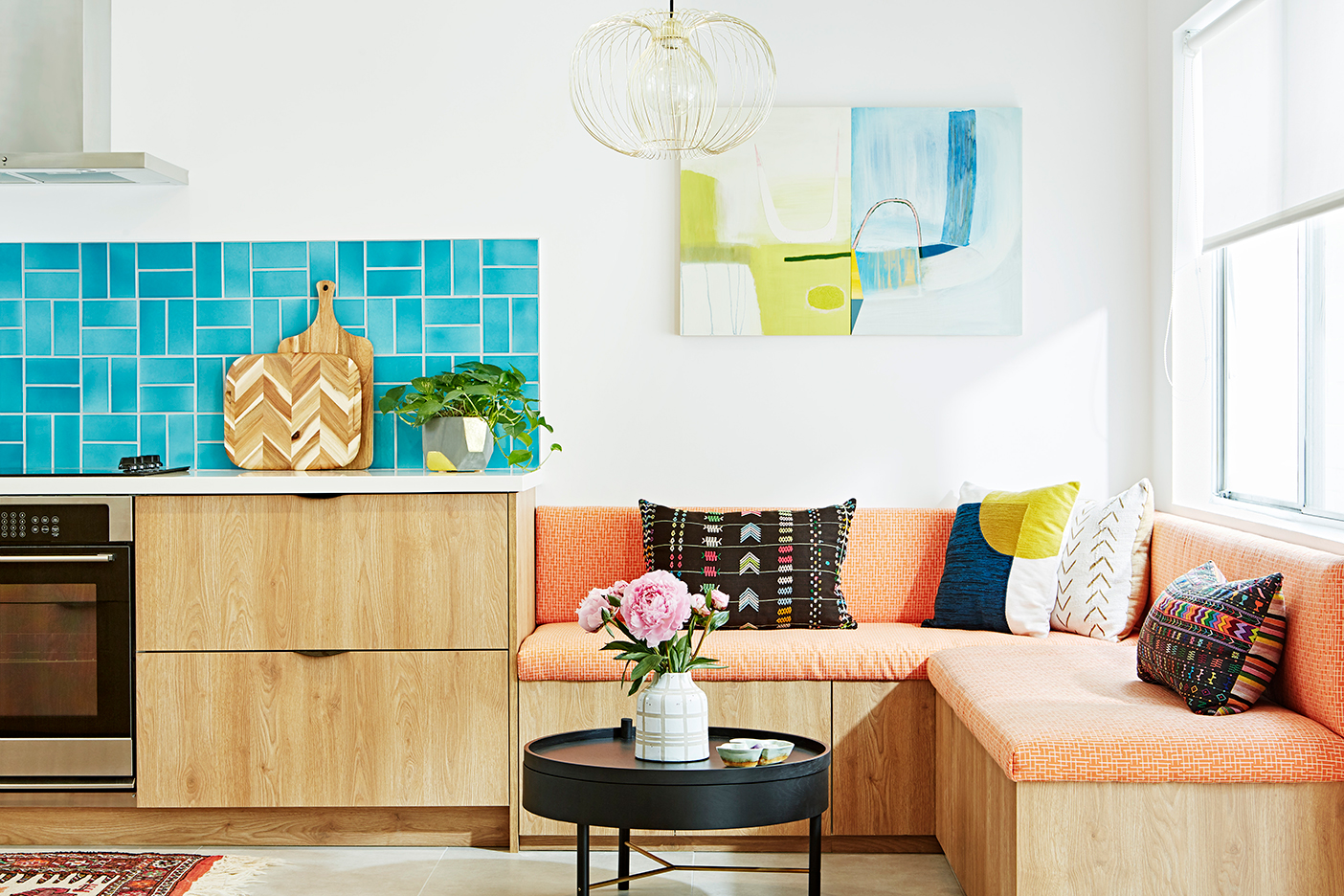 blue tile backsplash with colorful sofa