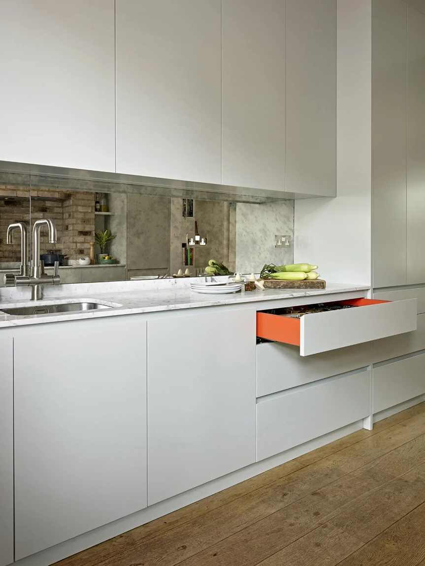 orange drawer in white kitchen