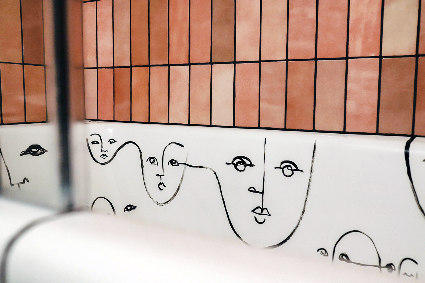 abstract faces drawn inside tub