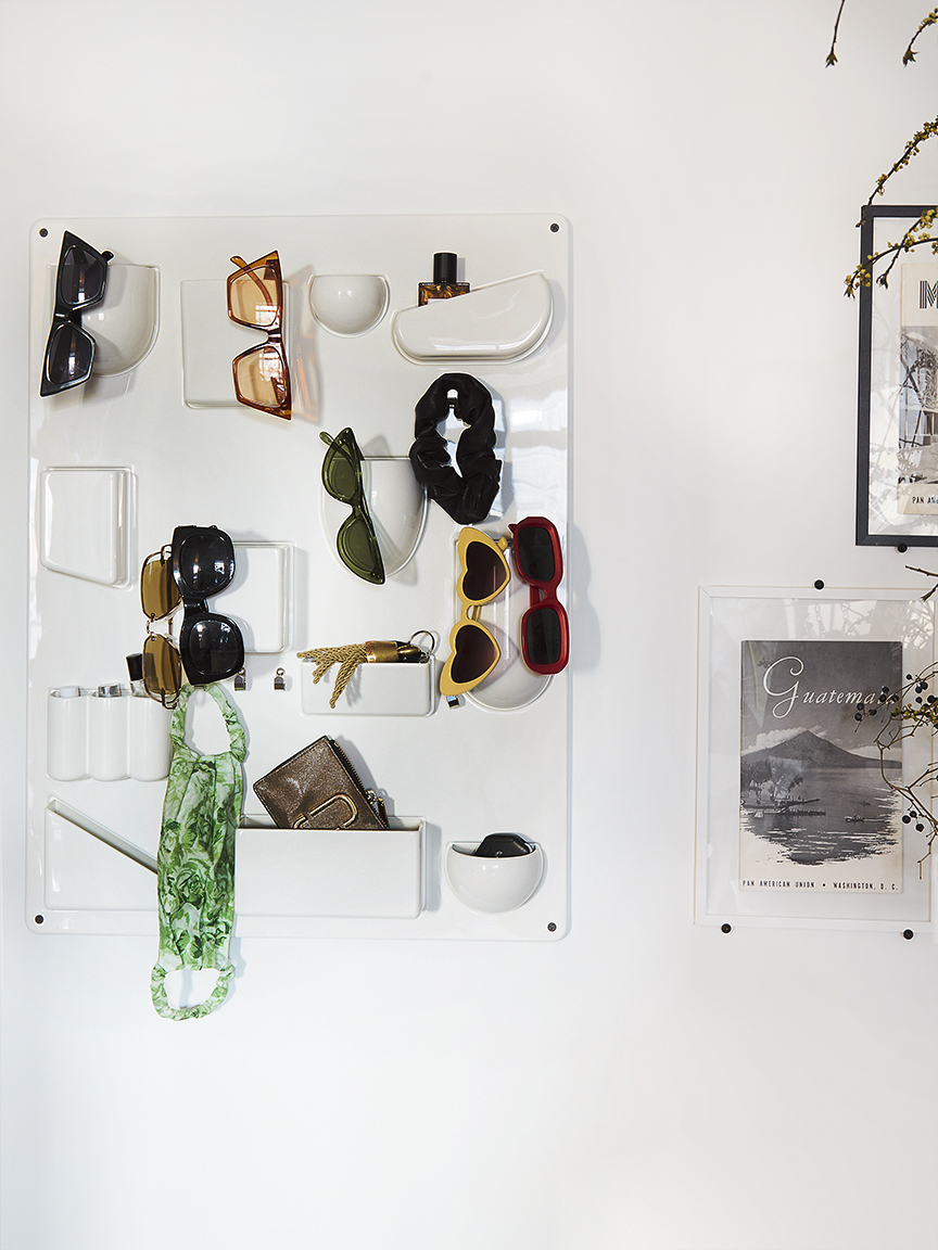 wall organizer filled with sunglasses