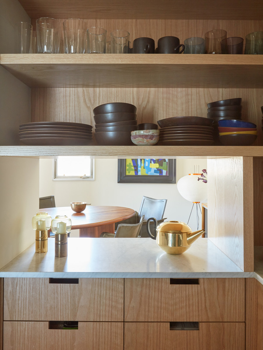 wood cabinets with peep hole into living room