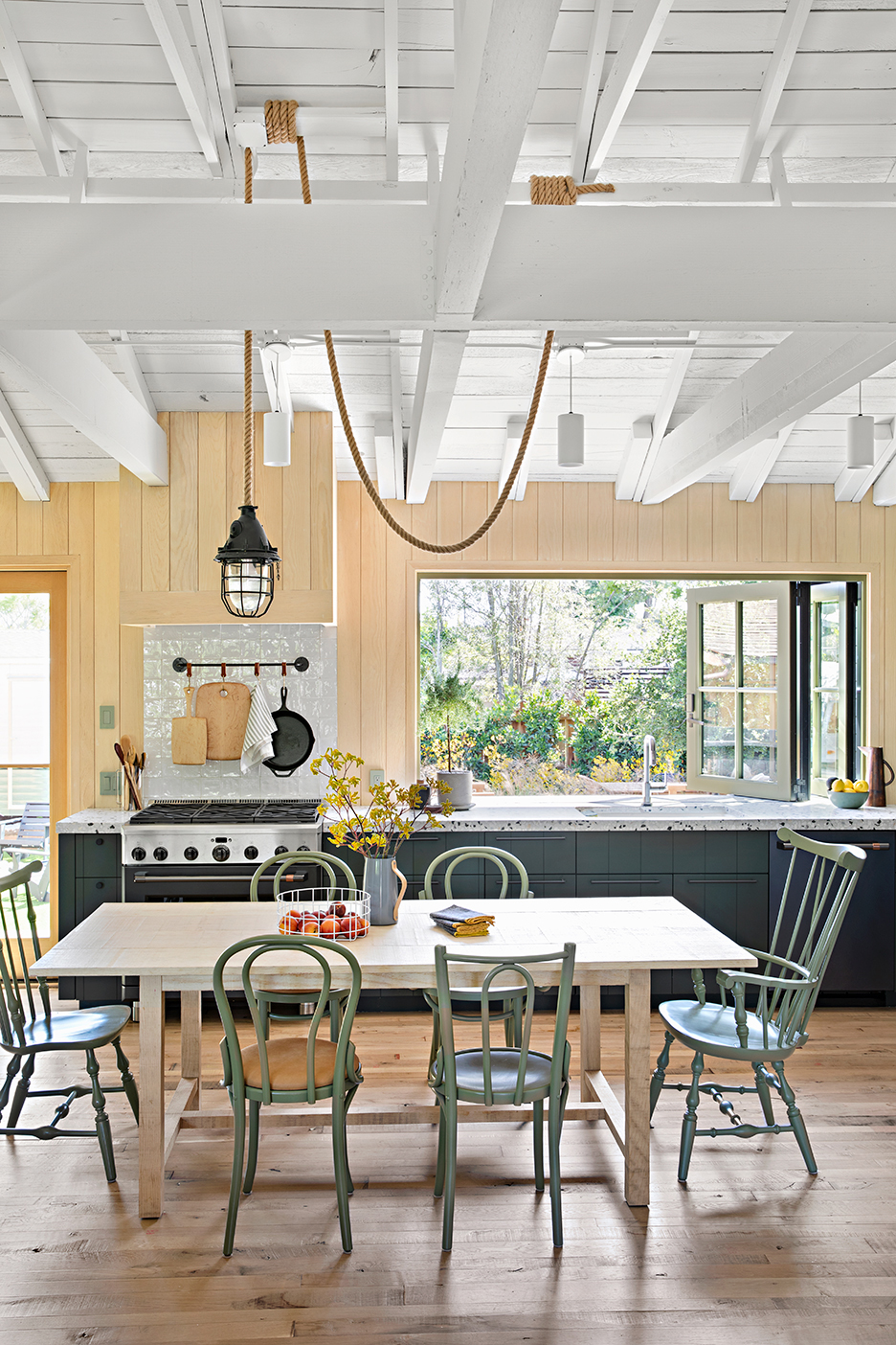 green and wood kitchen with high ceilings