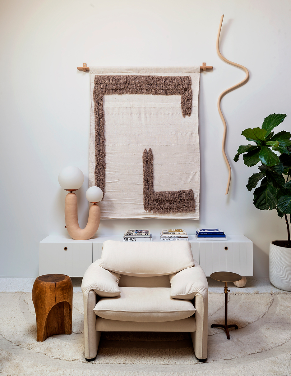 Living room with cozy chair and wall tapestry