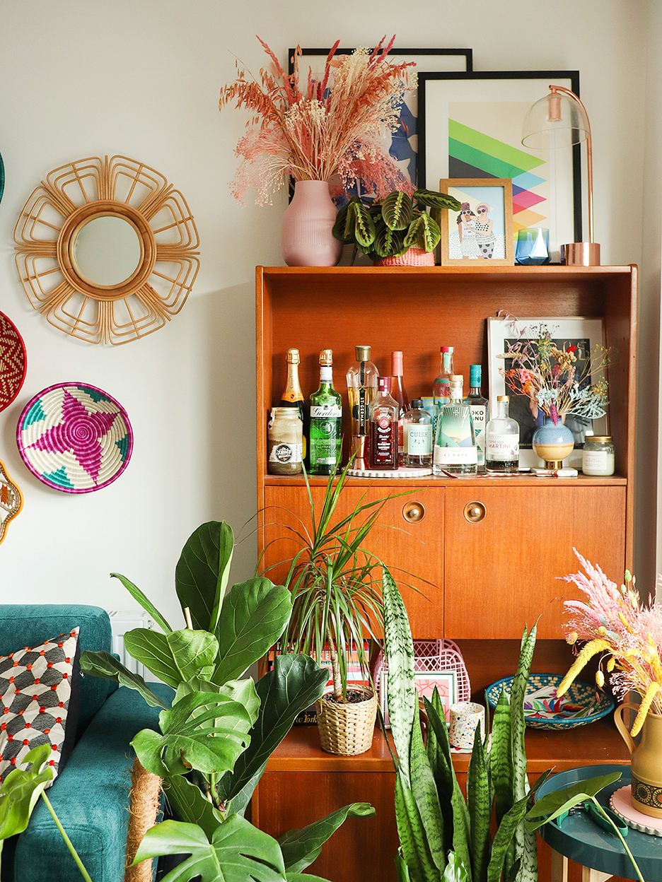 mid century bar cabinet surrounded by plants