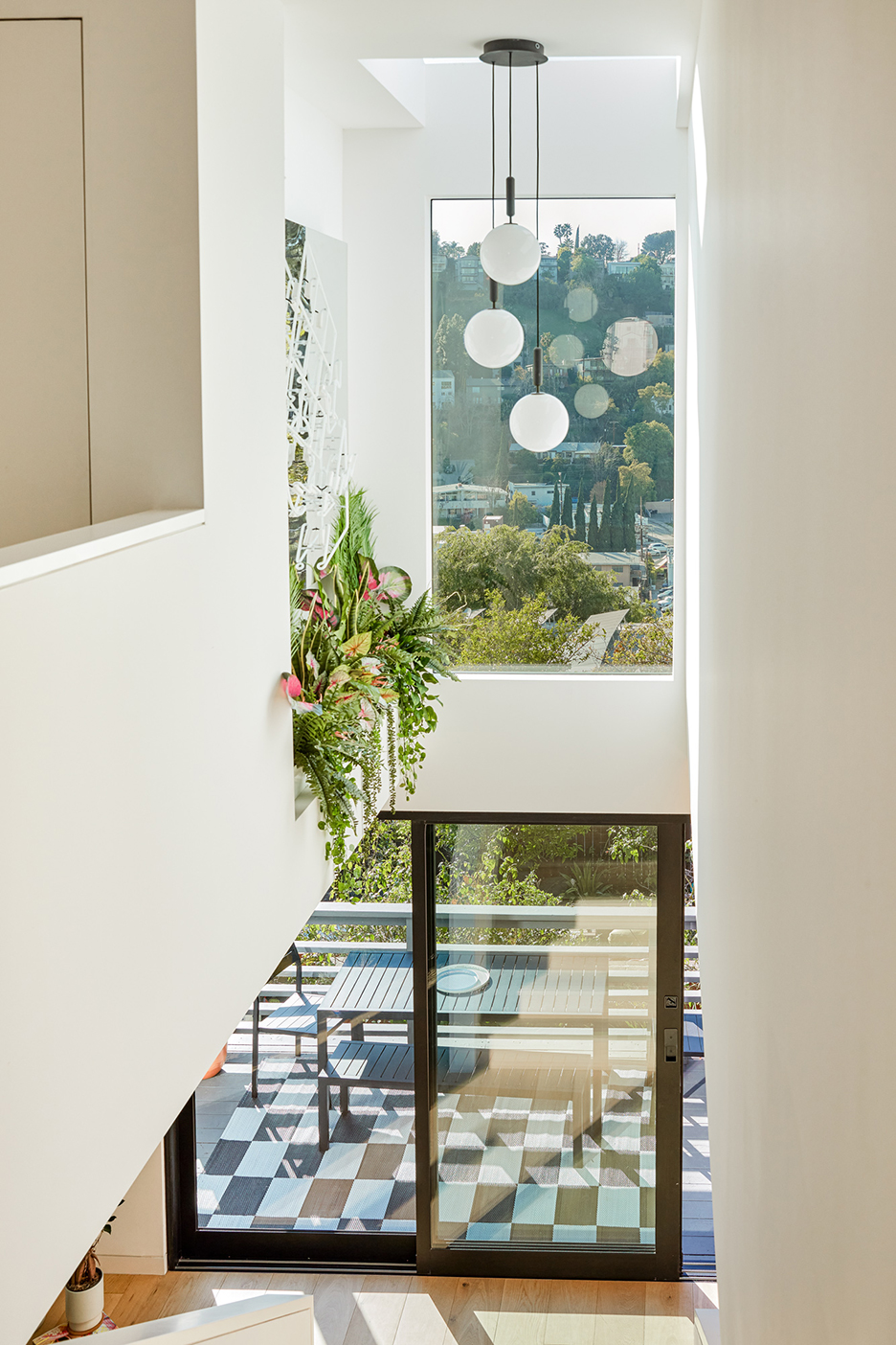 staircase with plants coming down over top