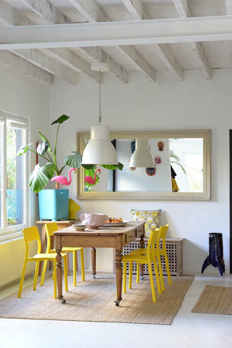 a dining room with yellow chairs