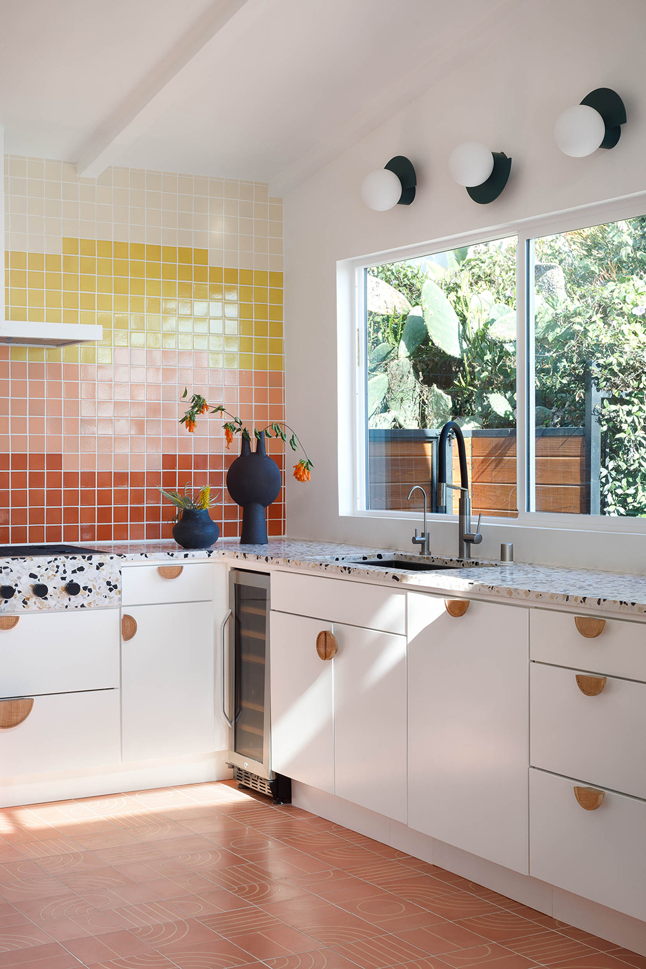 white lower cabinets with big window over sink