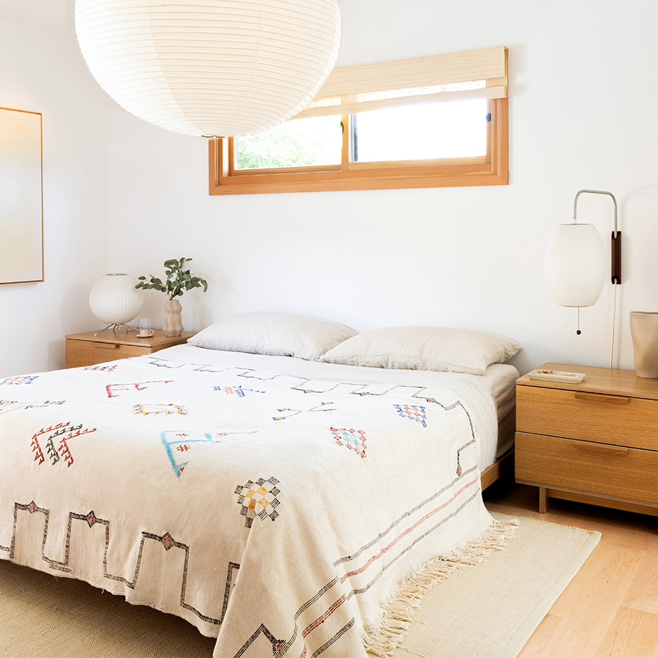 whtie bedroom with large lantern over bed