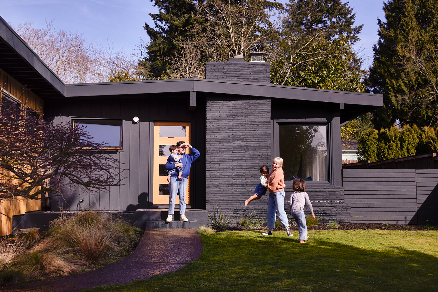 family playing outside house