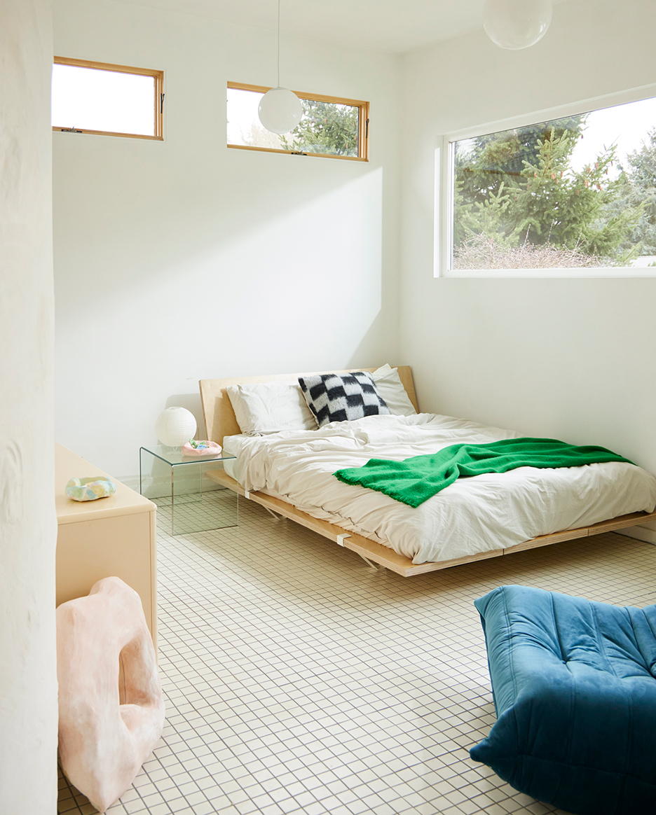 bed in a white tiled room